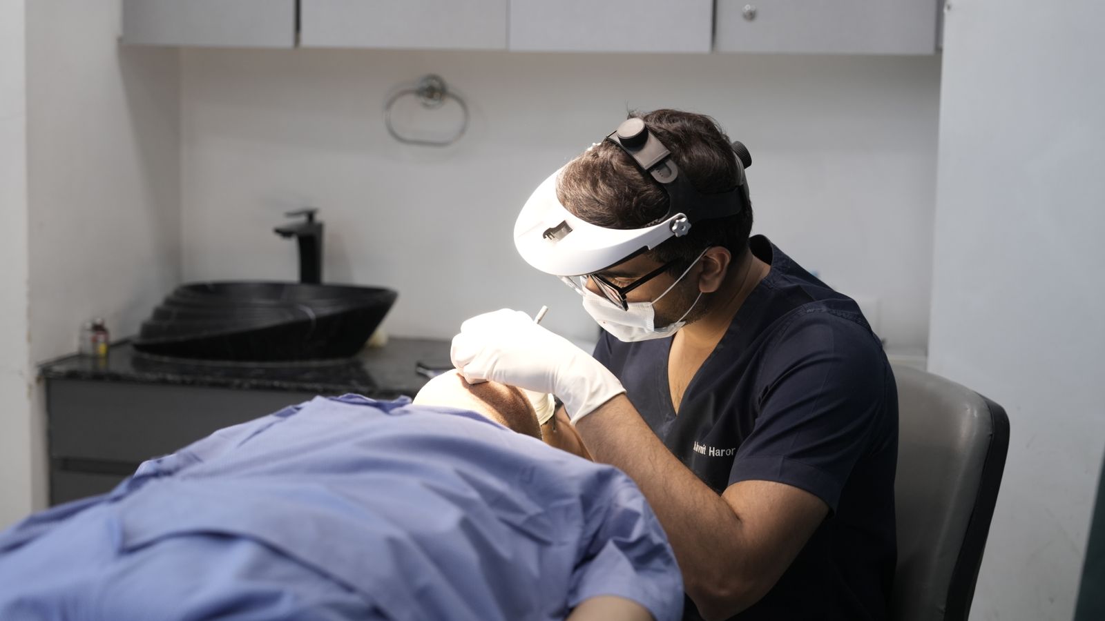 Trichologist in Chester examining a patient's scalp and hair