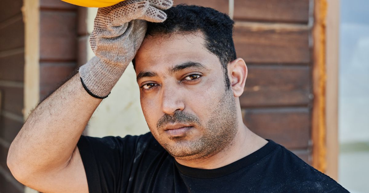 Construction worker resting with his hard hat in hand, the daily PPE a trichologist in Goole asks about