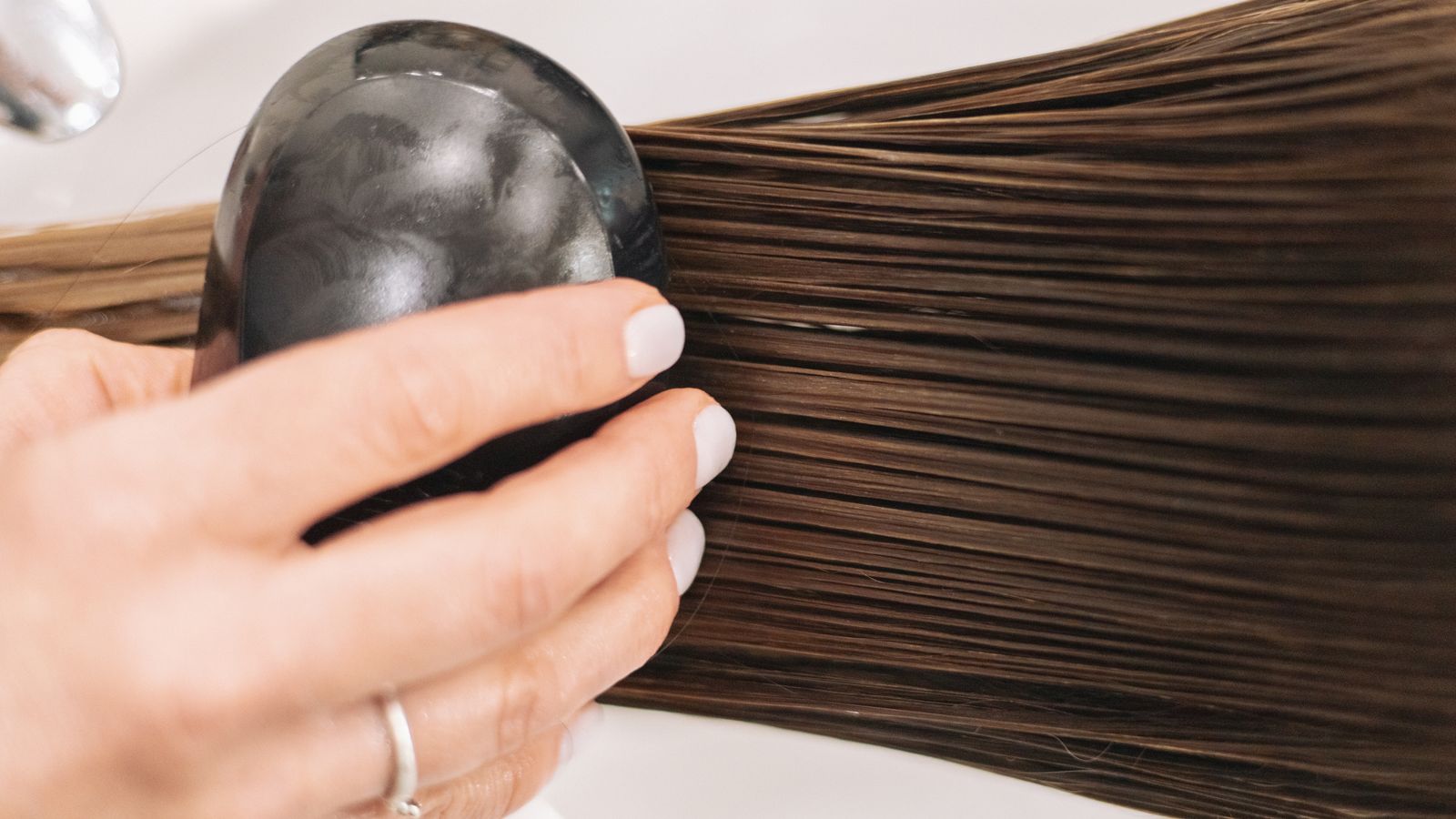 Close up of long hair being brushed, the everyday hair care a trichologist in Hounslow reviews