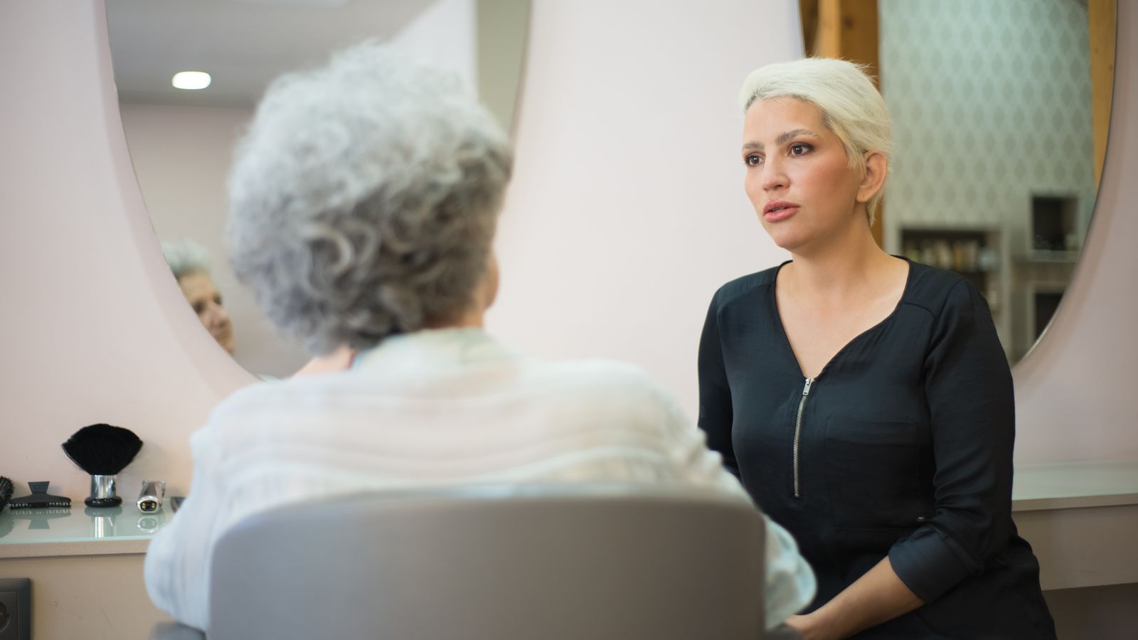 Client and hair specialist talking in a salon, a guide to trichologists in Ayr