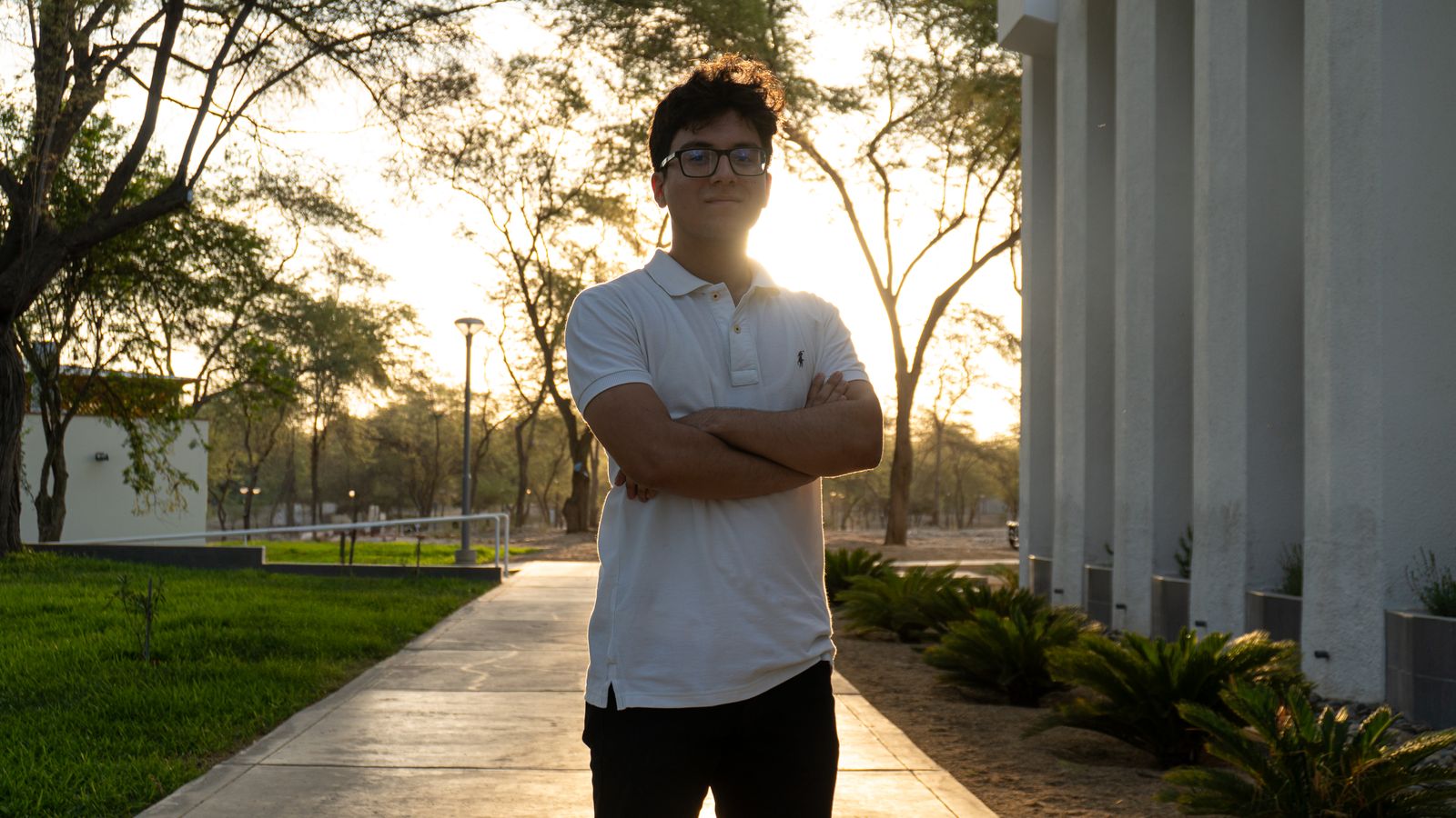 Young man on a university campus at sunset, the student population trichologists in Bangor often see