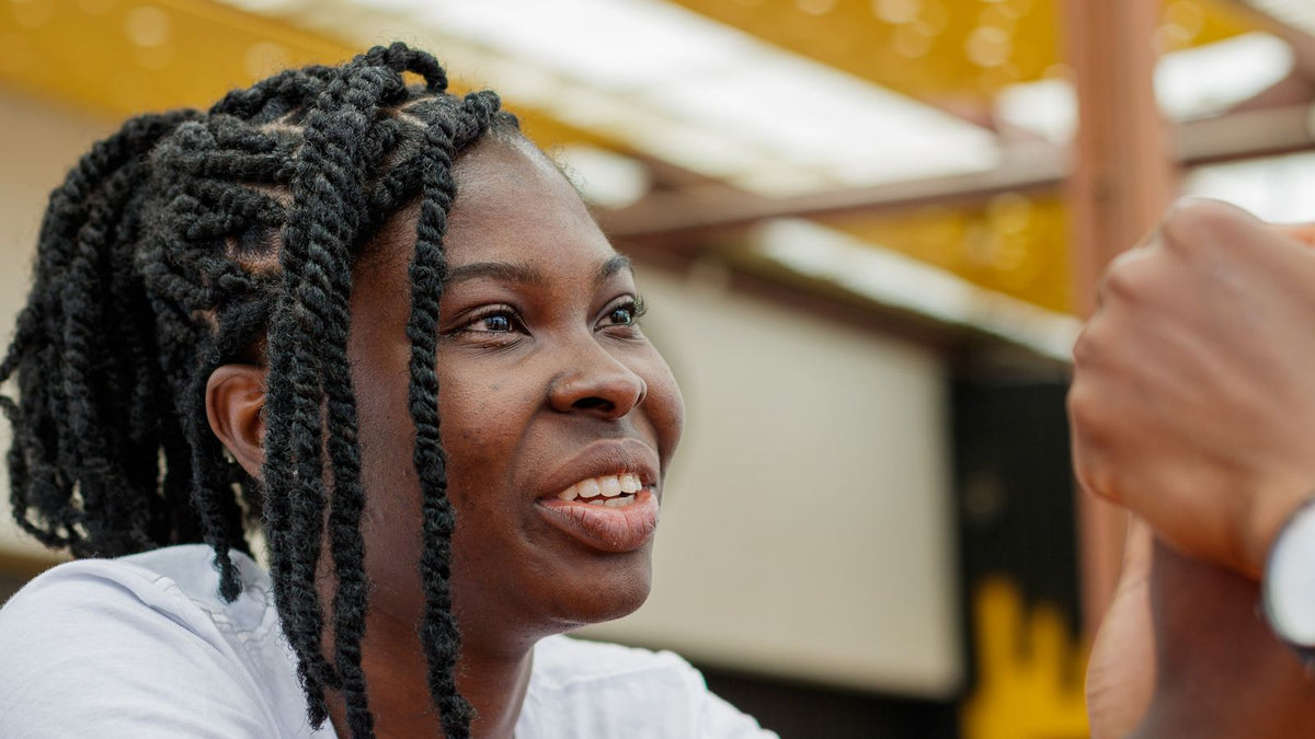Trichologists Barking: a smiling woman with long braided hair styled away from the hairline