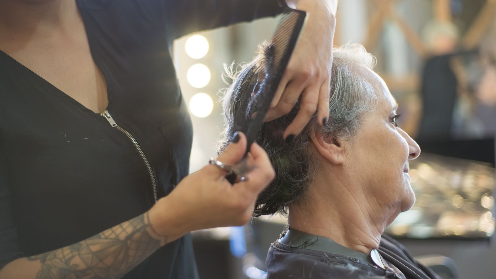 Hair specialist working with a client in a warm salon, a guide to trichologists in East Kilbride