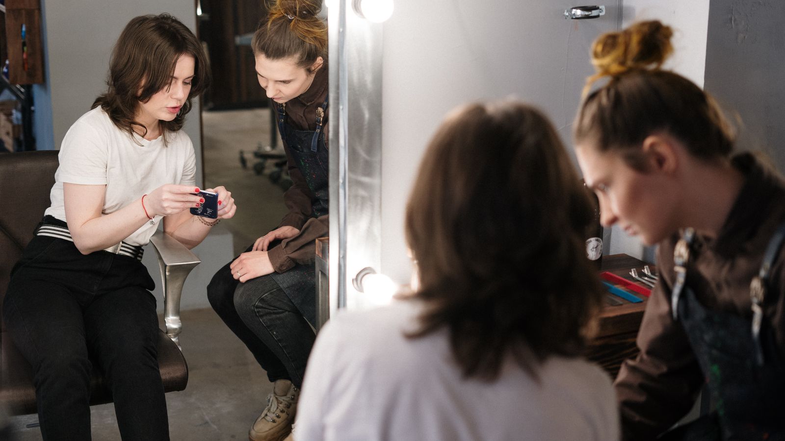 Two women in a hair consultation at a salon, a guide to trichologists in Hamilton