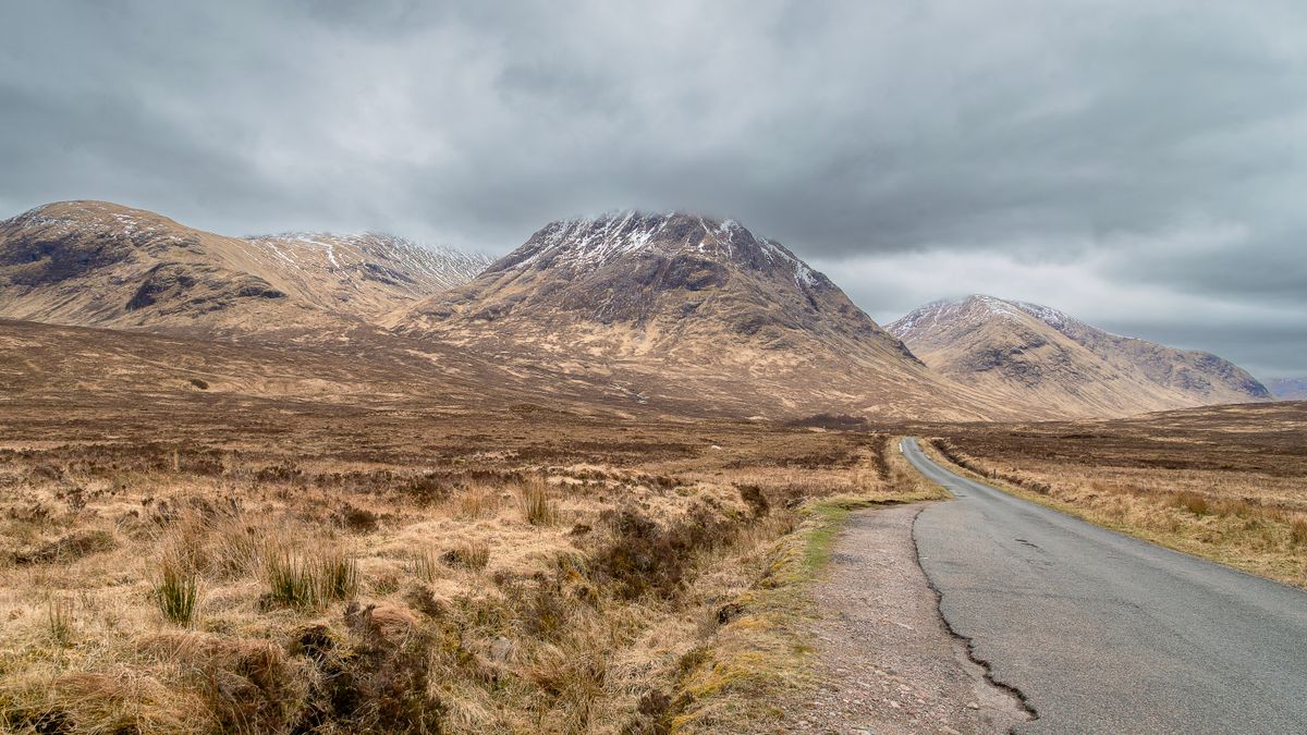 Empty road running through the remote Scottish Highlands, the distance behind searches for trichologists Inverness