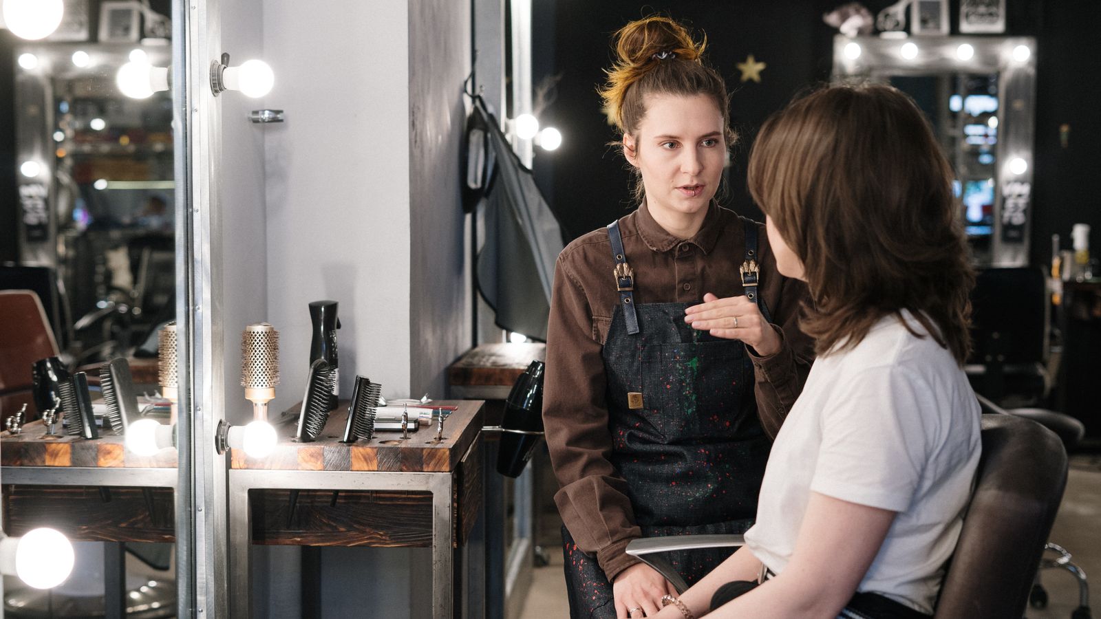 Hair specialist consulting a client in a modern salon, a guide to trichologists in Livingston