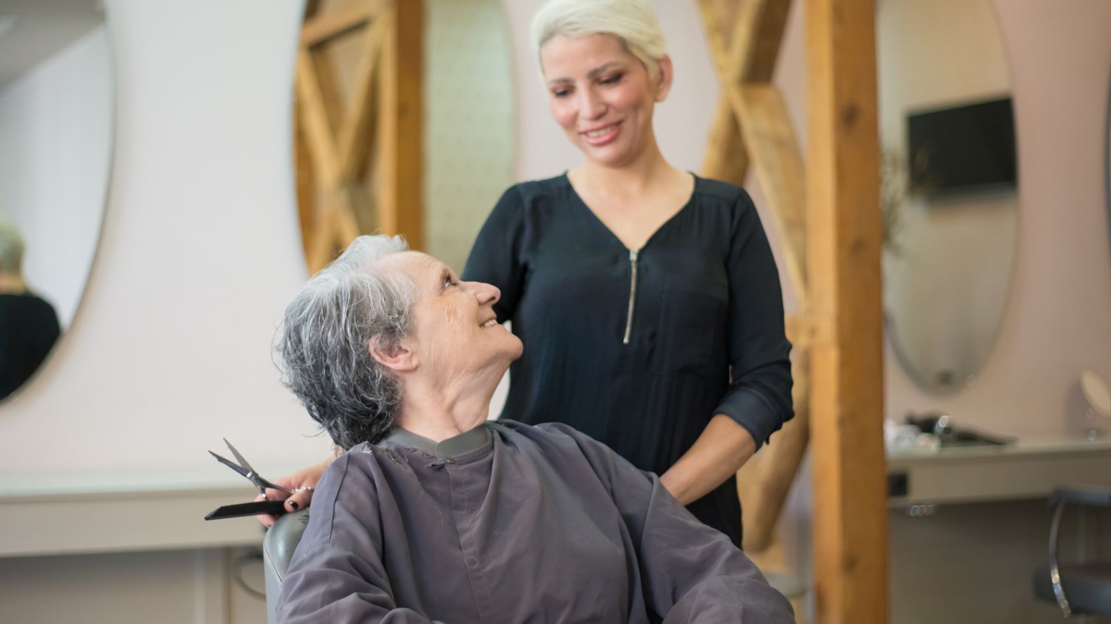 Trichologist in Macclesfield with a smiling older client after a scalp assessment