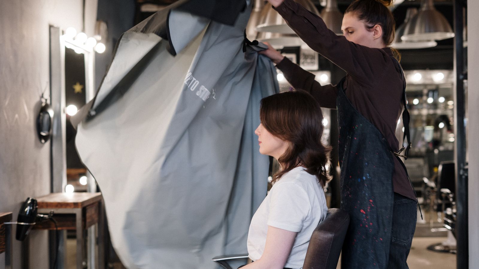 Hair specialist preparing a client for a consultation, a guide to trichologists in Perth
