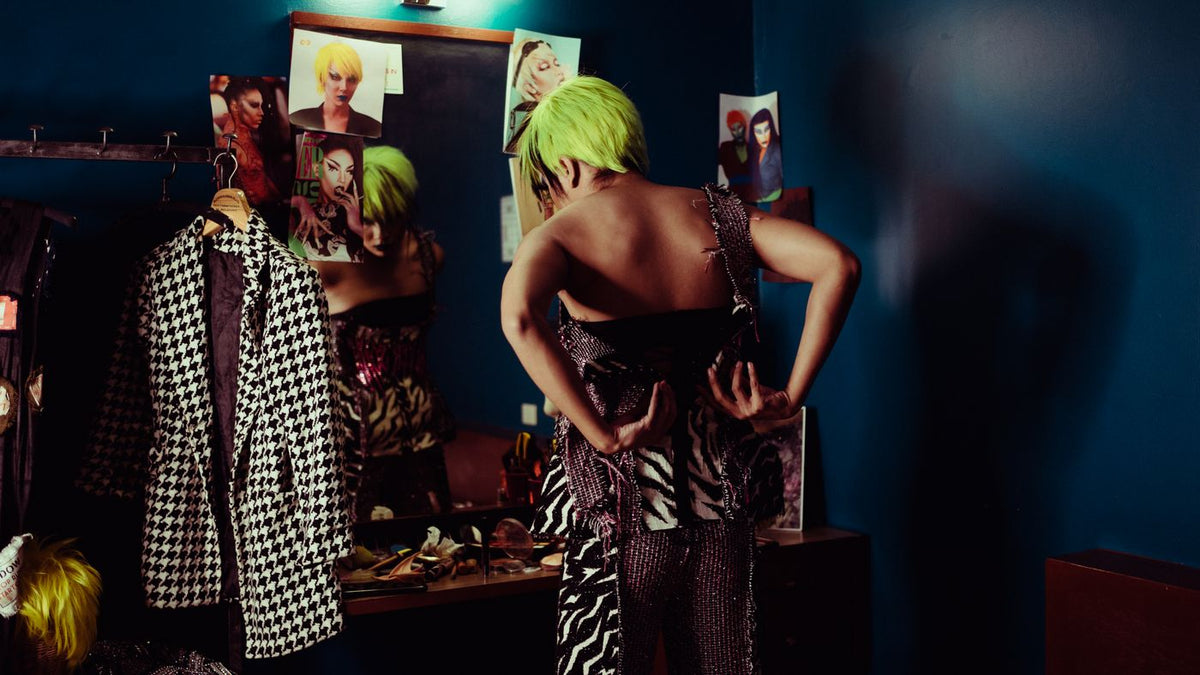 Trying on a hairpiece in front of a mirror, one of the cover-up options trichologists Redditch get asked about