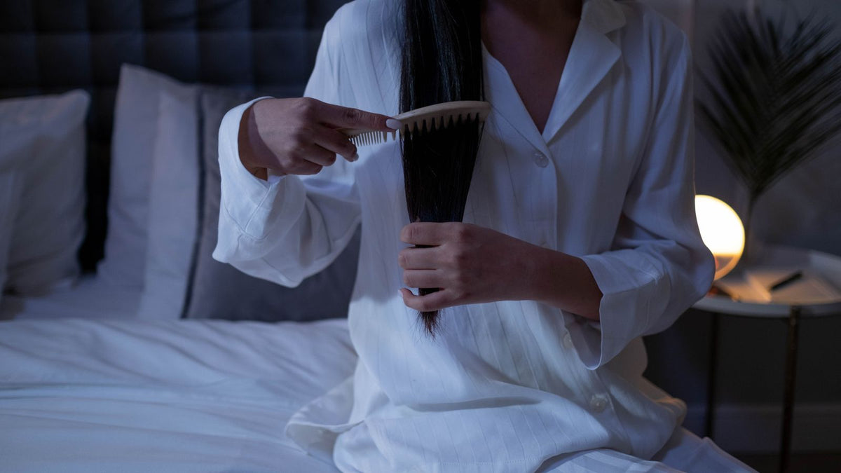 Woman combing her long hair at home, a routine surrounded by myths that trichologists West Bromwich hear about