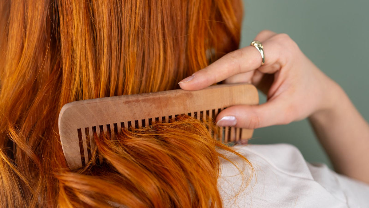 Woman combing long healthy hair, illustrating what vitamin K2 for hair can and cannot do