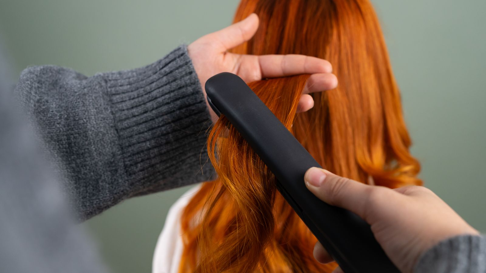 Flat iron heat styling long hair, a leading cause of hair damage