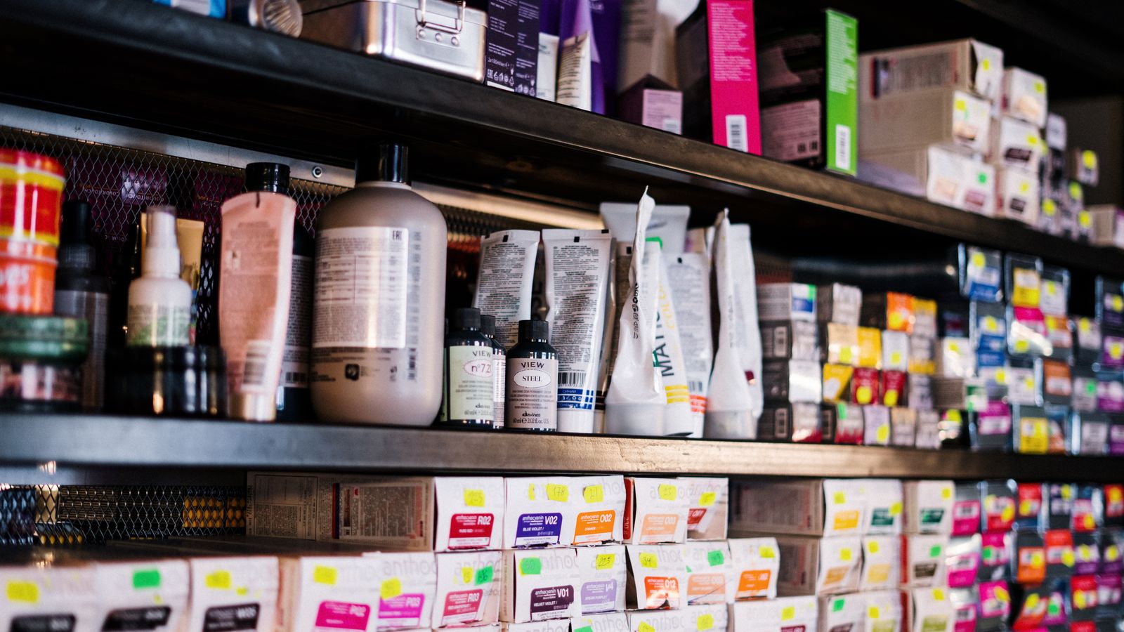 Hair products lined up on a salon shelf, showing what order to apply hair products