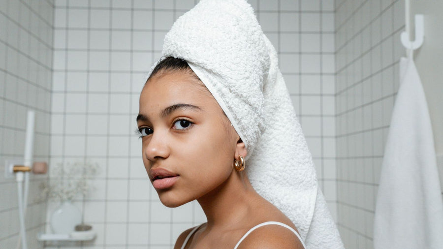 Blotting wet hair in a towel, the stage when hair breakage happens most